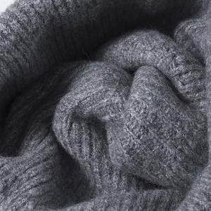Unisex chunky knit beanie in dark grey wool blend showing a soft and thick texture