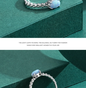 Detail of S925 silver beaded ring with oval blue opal stone and vintage texture