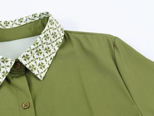 Detail of army green dress with geometric print collar and coordinated buttons