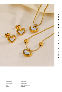 Detail of shell heart jewelry set including gold necklace bracelet and earrings