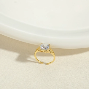 Detailed view of an adjustable gold ring featuring a sparkling square zircon stone