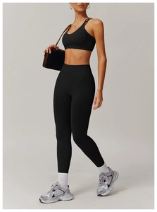 Close-up of black yoga set with cross-back sports bra and high-waist leggings