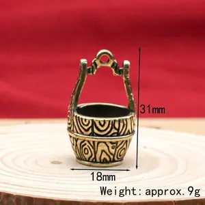Miniature brass feng shui bucket charm with intricate wood grain texture, 31mm tall