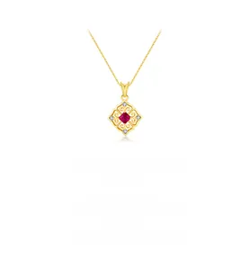 Detail of vintage gold necklace featuring a red gemstone pendant with zircon accents
