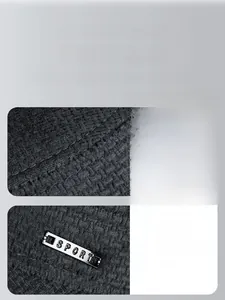 Detail of black waffle knit texture and sport metal badge on thermal winter hat