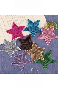 Macro detail of star sequin patches in eight colors for DIY clothing embroidery