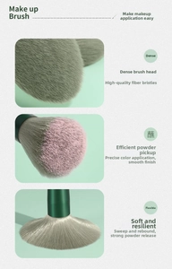 Detail of dense fiber bristles on a green makeup brush showing efficient powder pickup