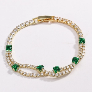 Detail of gold tennis bracelet with 4mm emerald square stones and zircon stones