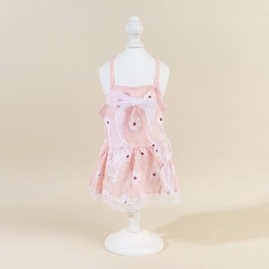 Detail of pink pet floral dress with daisy print and large white mesh bow decoration