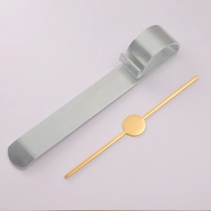 Macro detail of polished silver U-hook and golden metal disc bar for DIY jewelry making