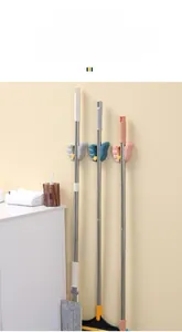 Detail of adjustable wall-mounted broom holder with anti-slip silicone pads and hooks