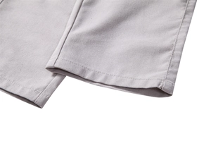 Detailed close-up of double-stitched hem and twill texture on men's casual linen pants