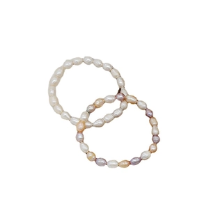 Elegant freshwater pearl and jade bracelets with minimalist vintage design on white background