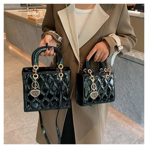 Detailed comparison of large and small quilted patent leather bags with gold hardware