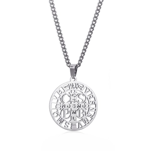 Close-up of silver stainless steel Saint Benedict medal with intricate hollow cross detail