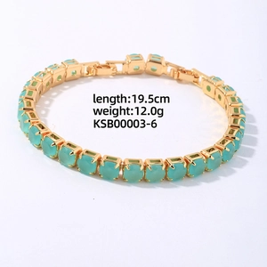 Detail view of 19.5cm gold plated bracelet featuring light green square zircon stones