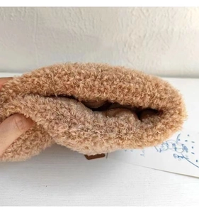 Close-up of thick light brown plush faux fur material showing soft texture and warmth
