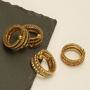 Detail of vintage 18K gold plated wide chain rings set with emerald and onyx stones