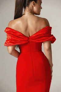 Detail of red off-shoulder evening dress featuring back invisible zipper and satin texture