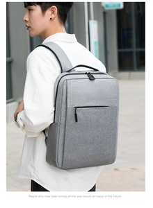 Side view of gray minimalist backpack with padded straps and large front pocket
