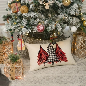 Detailed view of linen lumbar pillow with festive Christmas tree prints and holiday decor
