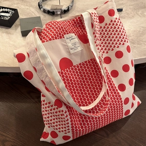 Canvas tote bag featuring red polka dots and moon patterns on a cream fabric base