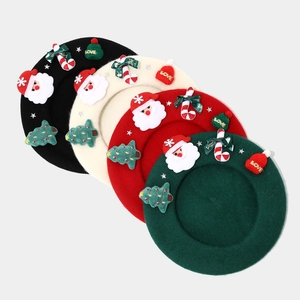 Detail of wool berets in four colors with 3D Santa and Christmas tree decorations