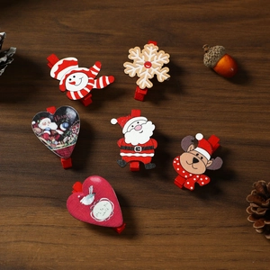 Christmas wooden clips set with Santa and reindeer on a dark wood background
