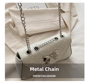 Detailed macro view of sparkling sequins with a silver metal bow on a chain shoulder bag