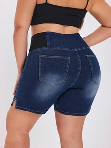 Detail of dark blue denim shorts featuring high elastic waistband and back pockets