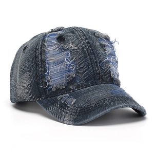 Close-up of distressed denim baseball cap showing vintage frayed edges and ripped details