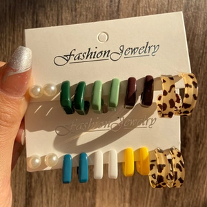 Detail view of 10-pair gold earring set with pearls and leopard print on display card