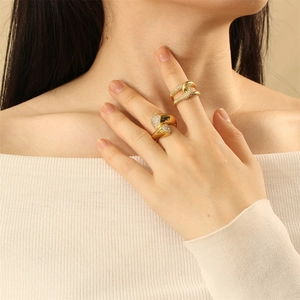 Close-up of elegant multilayer gold-plated rings with zircon inlay on a hand