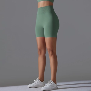 Detail of avocado green seamless high-waist yoga shorts with ribbed tummy control texture