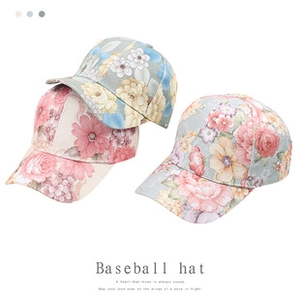 Close-up of floral print mesh baseball caps in pink and blue grey with retro sun visor