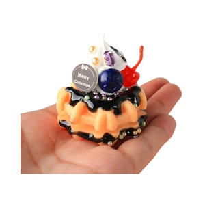 Christmas waffle keychain with cream and berries held in hand against white background