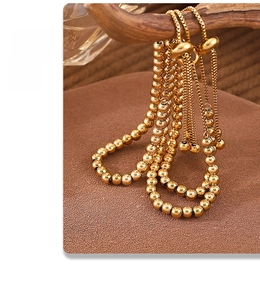 Detail of 18K gold plated steel bead bracelet with adjustable slide clasp mechanism