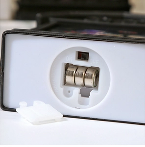 Detailed macro view of the lantern's base showing battery compartment with 3 button cells