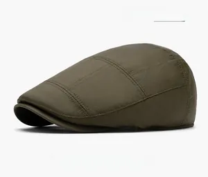 Detail view of military green newsboy cap with fine horizontal texture on white background
