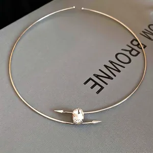 Minimalist silver choker necklace with an oval crystal and arrow accents for women