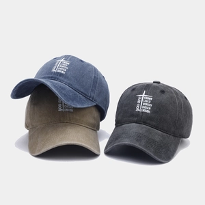 Detailed view of washed vintage cotton baseball caps with inspirational cross print