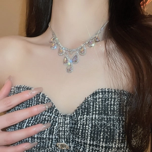 Detail of silver layered necklace set with sparkling teardrop rhinestones on model