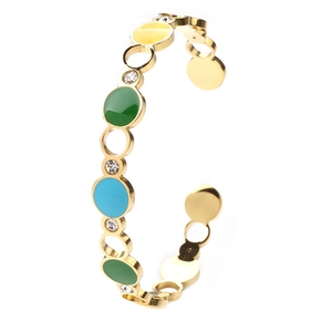 Detail of gold C-shaped cuff bracelet with colorful enamel rings and zircon crystals