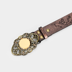 Detailed macro of brown embossed leather belt with bronze buckle and yellow gemstone