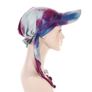 Detailed side view of tie-dye headscarf cap with blue purple floral pattern and ribbons