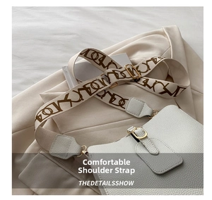 Close-up of white lychee leather bucket bag featuring a wide patterned fabric strap