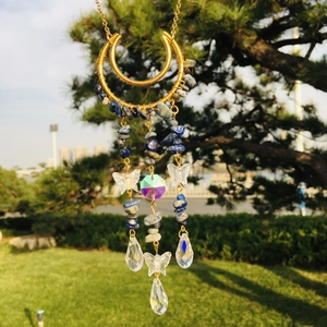 Detail of moon suncatcher with blue lapis lazuli stones and crystal butterfly pendant