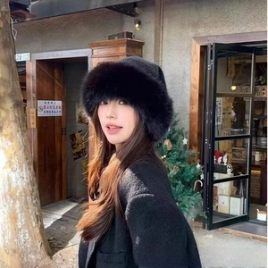 Close-up of thick black faux fur hat with warm plush lining and stylish winter design