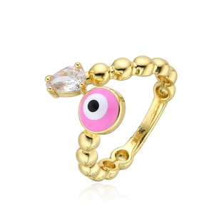 Golden evil eye ring with pink enamel and pear-shaped zircon on a beaded band