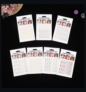 Detailed set of assorted adhesive face diamonds and flower stickers in retail packaging